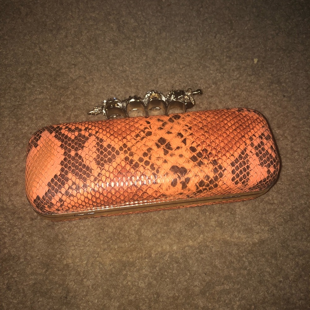 Orange snake skin clutch